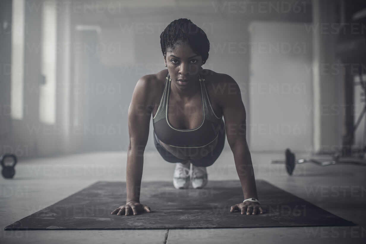 Premium Photo  Strong athletic black woman in a gym doing push-up
