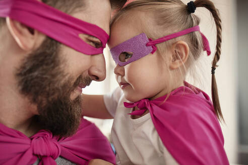 Father and daughter playing super hero and superwoman - ZEDF02511