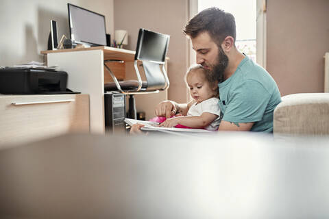 Father and daughter reading a book stock photo