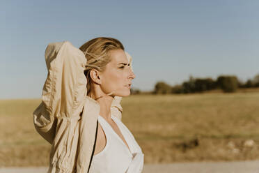 Portrait of female traveller with closed eyes - ERRF01589