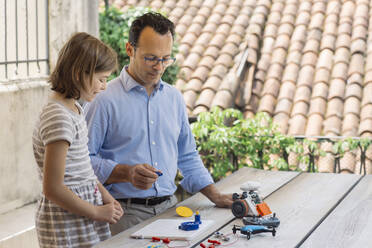 Father teaching his daughter electronics and robotics - ALBF00927