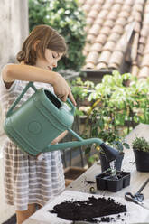 Girl repotting plant - ALBF00939