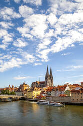 Ferry moving on Danube River by St. Peter's Church in Regensburg, Germany - PUF01658