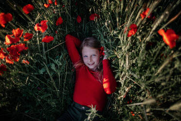 Little girl lying in poppy field - OGF00005