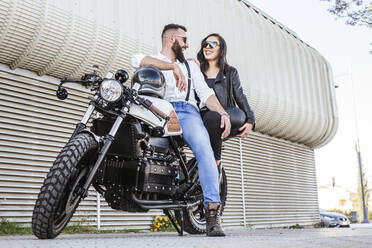 Laughing couple on motorbike - LJF00288