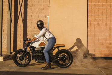 Man demonstrating his motorbike - LJF00300