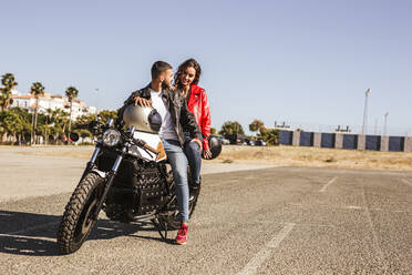 Couple sitting on motorbike - LJF00318