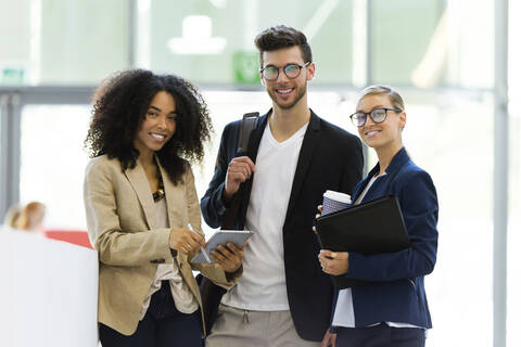 Portrait of young business people in a foyer stock photo