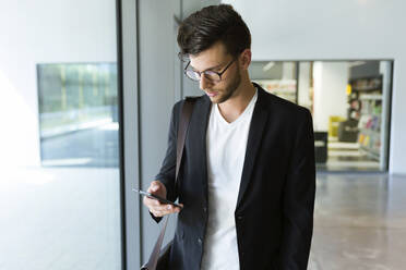 Young businessman using a smartphone - JSRF00404