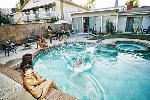 Man jumping into swimming pool stock photo