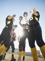 Football players celebrating on football field - BLEF08425