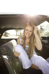 Smiling Caucasian woman sitting in car - BLEF08435