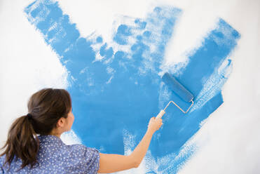 Mixed race woman painting wall - BLEF08513