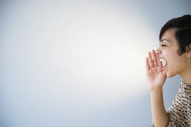 Close up of mixed race woman shouting - BLEF08546