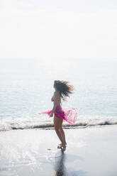 Caucasian woman wading at beach - BLEF08597