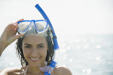 Caucasian woman wearing snorkel and mask in ocean - BLEF08605