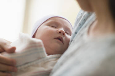 Asian mother holding newborn baby in hospital - BLEF08631