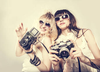 Caucasian women posing with cameras - BLEF08668