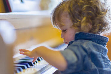 Caucasian baby boy playing piano - BLEF08689