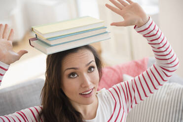 Woman balancing books on head - BLEF08711