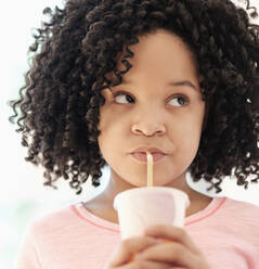 African American girl drinking with straw - BLEF08736