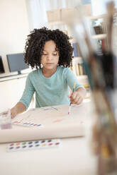 African American girl painting with watercolors - BLEF08740