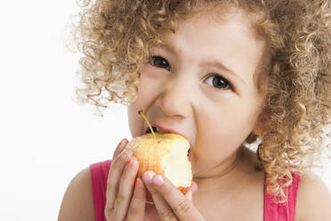 Mixed race girl eating apple - BLEF08792
