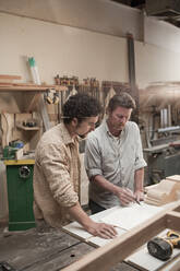 Co-workers woodworking in workshop - BLEF08815