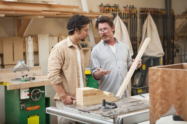 Co-workers woodworking in workshop - BLEF08816