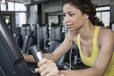 Mixed race woman exercising in health club - BLEF08823