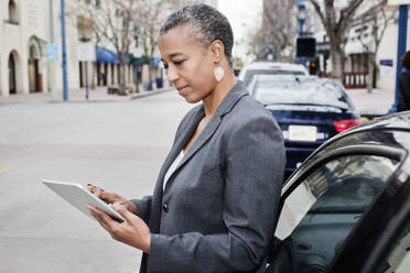 Black businesswoman using digital tablet outdoors - BLEF08836