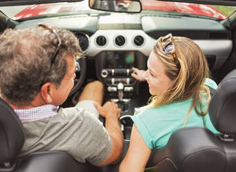 Caucasian couple driving convertible - BLEF08866