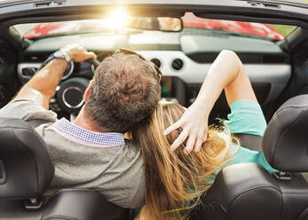 High angle view of Caucasian couple driving convertible - BLEF08867