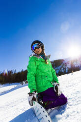 Mixed race teenager snowboarding - BLEF08931