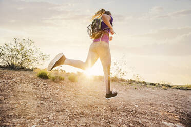 Caucasian woman running on remote hilltop - BLEF09107