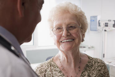 Hispanic doctor talking with older patient - BLEF09128