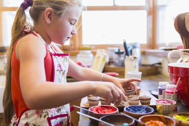 Caucasian girl making cupcakes - BLEF09161