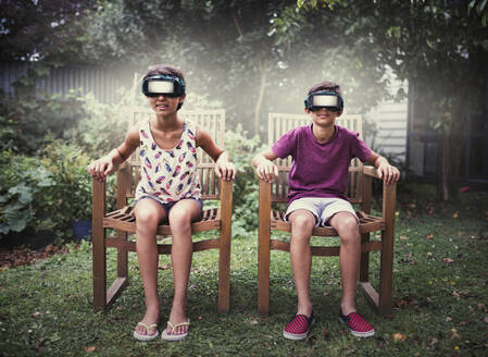 Mixed race children watching virtual reality screens - BLEF09346