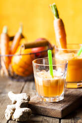 Glass of freshly squeezed apple-orange-carrot juice with ginger - SBDF03962