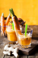 Glass of freshly squeezed apple-orange-carrot juice with ginger - SBDF03963