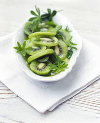 Dessert of fresh kiwi fruit and sweet-scented bedstraw leaves - PPXF00213