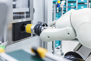 Arm of assembly robot functioning inside modern factory, Stuttgart, Germany - DIGF07198