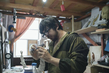 Sculptor working on an object - VPIF01284