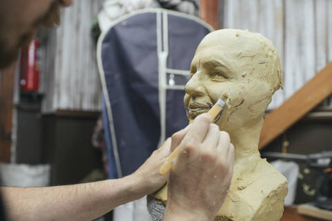 Sculptor working on a bust stock photo