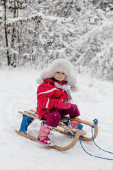 Girl sitting on a sledge - OGF00019