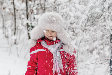 Portrait of a girl standing in a wintry forest - OGF00020