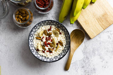 Bowl of fresh muesli and ingredients seen from above - GIOF06744