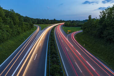 Germany, Baden-Wurttemberg, Blurred traffic lights on highway at dusk - WDF05319