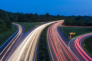 Germany, Baden-Wurttemberg, Blurred traffic lights on highway at dusk - WDF05320