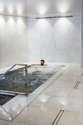 Man in a whirlpool in a spa - LJF00392